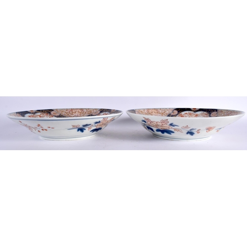 146 - A LARGE PAIR OF 18TH CENTURY JAPANESE EDO PERIOD IMARI PORCELAIN BOWLS painted with urns of flowers,... 