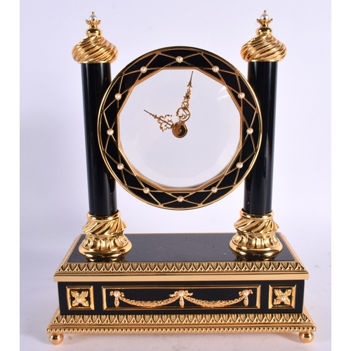 188 - A FRANKLIN MINT FABERGE MYSTERY CLOCK formed with a pearl mounted circular open dial, flanked by wyv... 