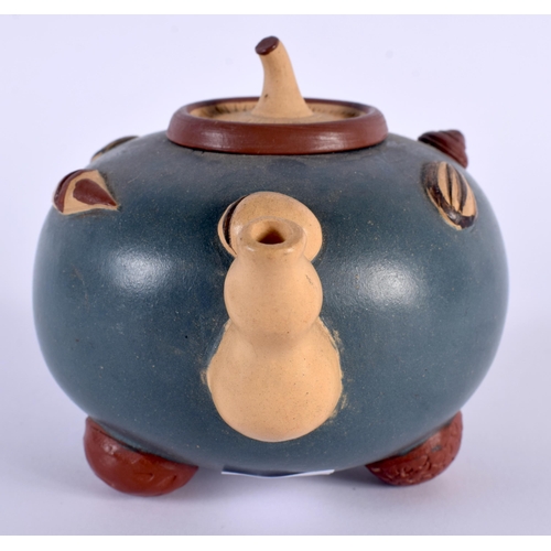 204 - AN EARLY 20TH CENTURY CHINESE YIXING POTTERY TEAPOT AND COVER overlaid with motifs. 13 cm wide.