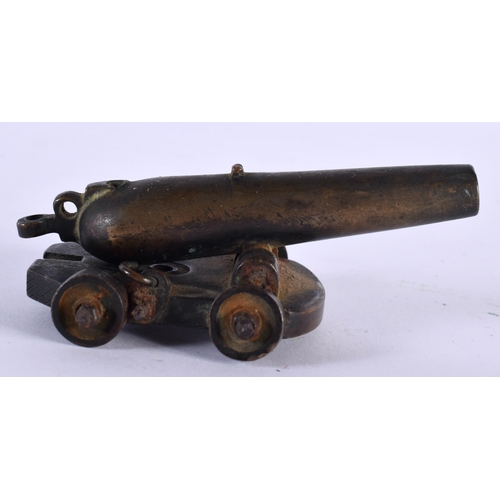 217 - A RARE GEORGE III MINIATURE COUNTRY HOUSE DESK CANNON modelled upon a bronze base with moving wheels... 