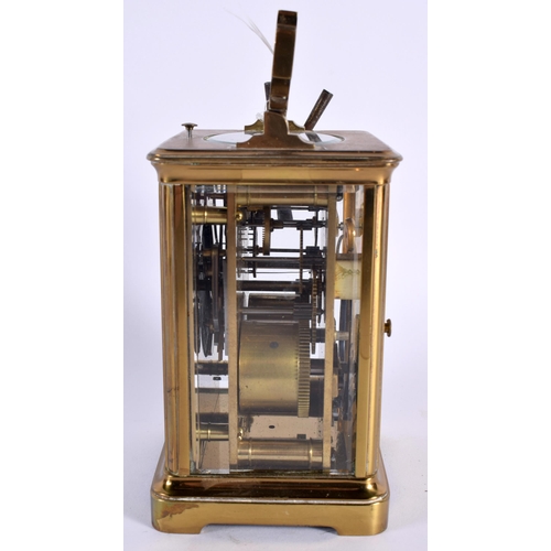 29 - AN ANTIQUE REPEATING CARRIAGE CLOCK. 15.5 cm high inc handle.