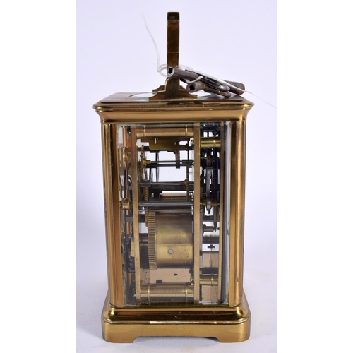 29 - AN ANTIQUE REPEATING CARRIAGE CLOCK. 15.5 cm high inc handle.