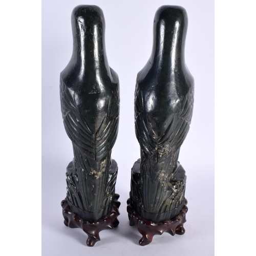 40 - A PAIR OF 19TH CENTURY CHINESE CARVED GREEN JADE FIGURES OF PARROTS Qing, each boldly modelled upon ... 