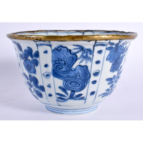 84 - A 17TH CENTURY CHINESE BLUE AND WHITE PORCELAIN RIBBED BOWL Kangxi, with brass rim, painted with spa... 