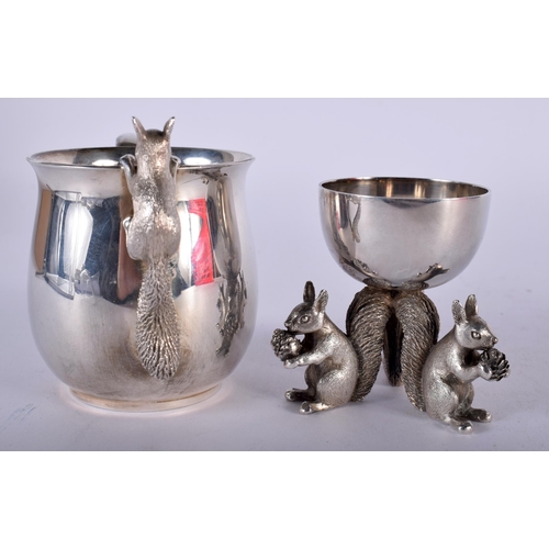 A Silver Mug with a Squirrel climbing on the rim together with a Silver ...