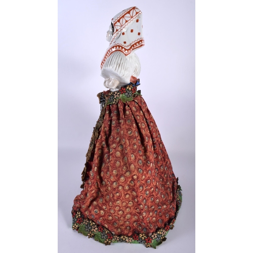 10 - A LARGE AND UNUSUAL EARLY 20TH CENTURY RUSSIAN EASTERN EUROPEAN PORCELAIN TEA COSY formed as a femal... 