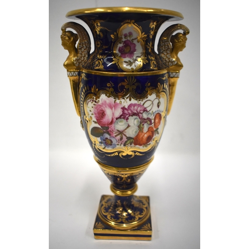 161 - Early 19th century vase with winged caryatid handles painted with lavish flowers on a cobalt blue gr... 