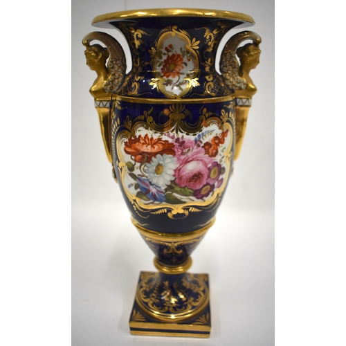 161 - Early 19th century vase with winged caryatid handles painted with lavish flowers on a cobalt blue gr... 