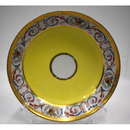 166 - Early 19th century Coalport rare yellow ground chocolate or caudle cup and stand painted with a bord... 