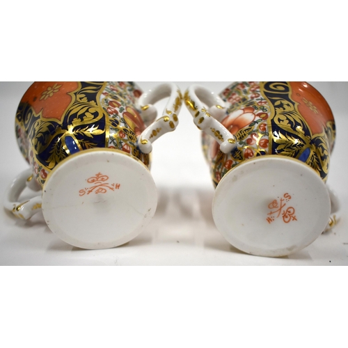 168 - 19th century Derby pair of two handled cups and saucer in an imari pattern, red mark.(4) cup 7.5cm h... 