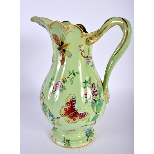 18 - AN EARLY VICTORIAN ENAMELLED BUTTERFLY JUG. 27 cm high.