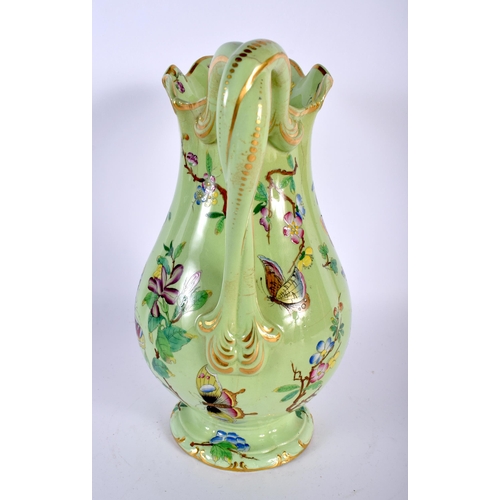 18 - AN EARLY VICTORIAN ENAMELLED BUTTERFLY JUG. 27 cm high.