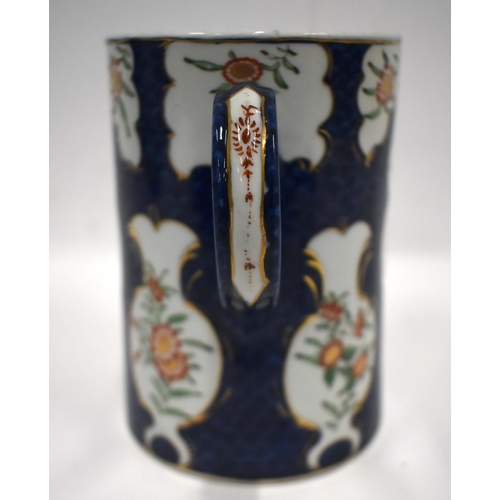 184 - 18th century Worcester mug painted in kakiemon style with two panels of oriental flowers on a blue s... 