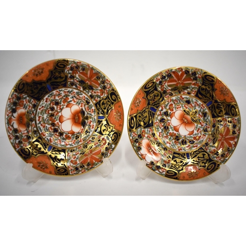 223 - 19th century Derby pair of two handled cups and saucer in an imari pattern, red mark.8cm high