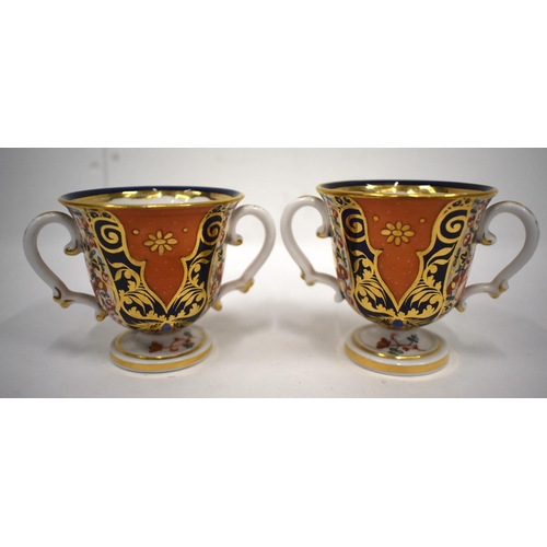 223 - 19th century Derby pair of two handled cups and saucer in an imari pattern, red mark.8cm high