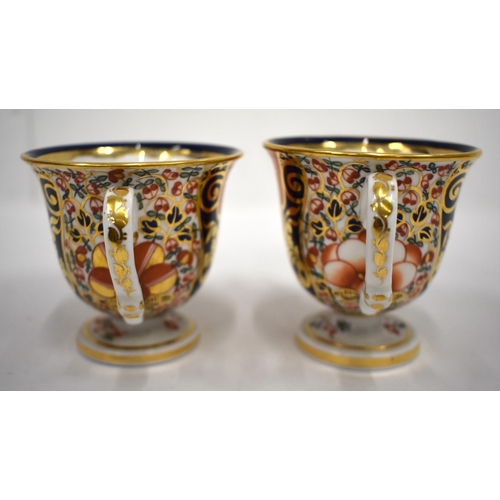 223 - 19th century Derby pair of two handled cups and saucer in an imari pattern, red mark.8cm high