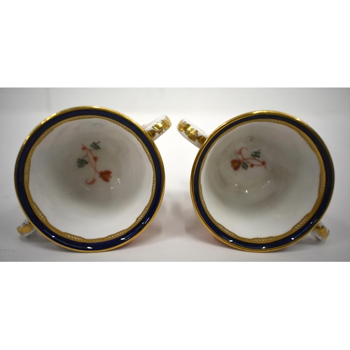 223 - 19th century Derby pair of two handled cups and saucer in an imari pattern, red mark.8cm high