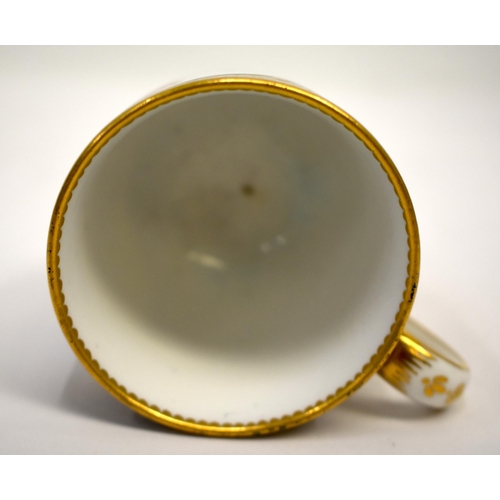 269 - 18th century Sevres coffee cup painted with a cherub on a cloud in an oval panel on a dark blue grou... 