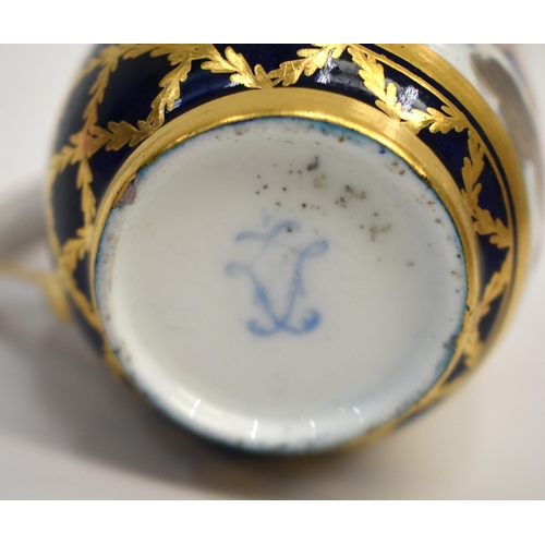 269 - 18th century Sevres coffee cup painted with a cherub on a cloud in an oval panel on a dark blue grou... 