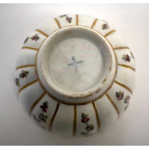 284 - 18th century Bristol teabowl and saucer painted with rose chains in gilt panels, X in blue on teabow... 