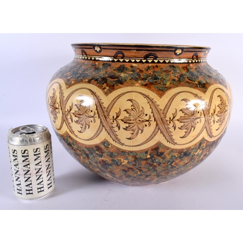 306 - A LARGE ARTS AND CRAFTS MINTON POTTERY JARDINIERE painted in mocha tones with foliage and vines. 30c... 