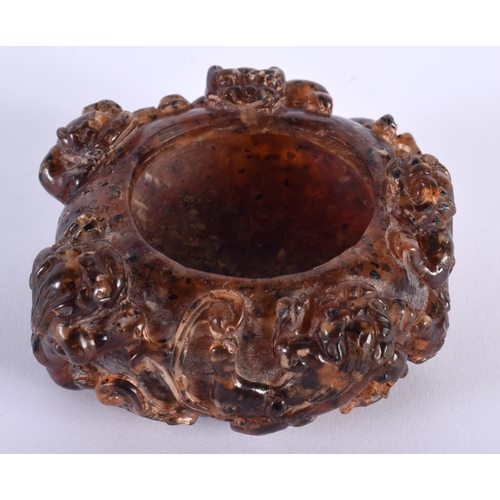 353 - A CHINESE QING DYNASTY CARVED AMBER SCHOLARS BRUSH WASHER overlaid with clambering buddhistic lions.... 