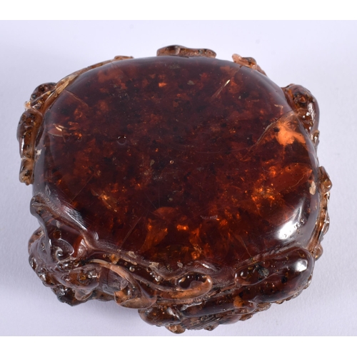 353 - A CHINESE QING DYNASTY CARVED AMBER SCHOLARS BRUSH WASHER overlaid with clambering buddhistic lions.... 