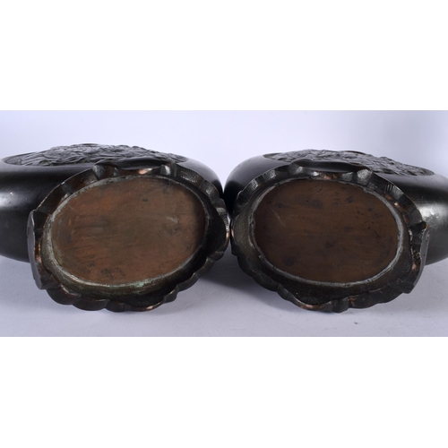 373 - A PAIR OF 19TH CENTURY CHINESE BRONZE PILGRIM MOON FLASKS Qing, decorative with immortals within a c... 