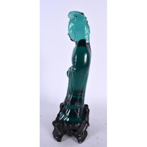 375 - A RARE CHINESE QING DYNASTY GREEN PEKING GLASS FIGURE OF AN IMMORTAL modelled upon a fitted hardwood... 