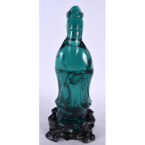 375 - A RARE CHINESE QING DYNASTY GREEN PEKING GLASS FIGURE OF AN IMMORTAL modelled upon a fitted hardwood... 