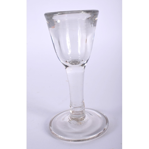 38 - A GEORGE III WINE GLASS together with four glass paperweights. (5)
