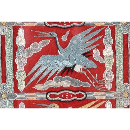 385 - AN UNUSUAL 19TH CENTURY CHINESE RED SILK EMBROIDERED EIGHT CRANE PANEL Qing. 54 cm x 44 cm.