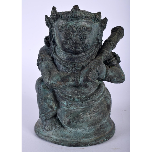 386 - AN ANTIQUE HINDU JAVANESE BRONZE FIGURE OF BATHARA KALA modelled holding a gada. 14 cm x 8 cm.