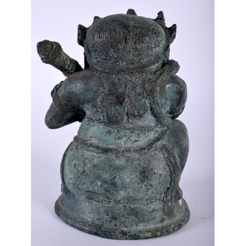 386 - AN ANTIQUE HINDU JAVANESE BRONZE FIGURE OF BATHARA KALA modelled holding a gada. 14 cm x 8 cm.