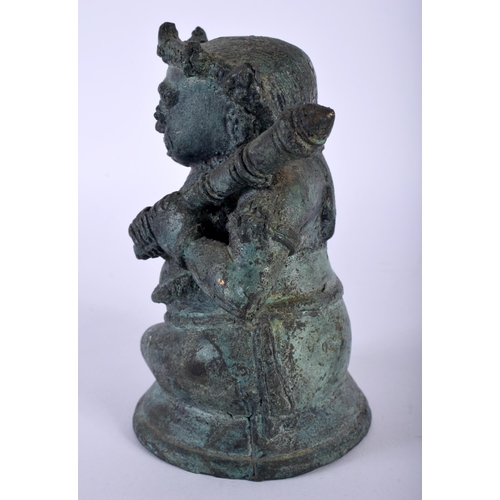 386 - AN ANTIQUE HINDU JAVANESE BRONZE FIGURE OF BATHARA KALA modelled holding a gada. 14 cm x 8 cm.