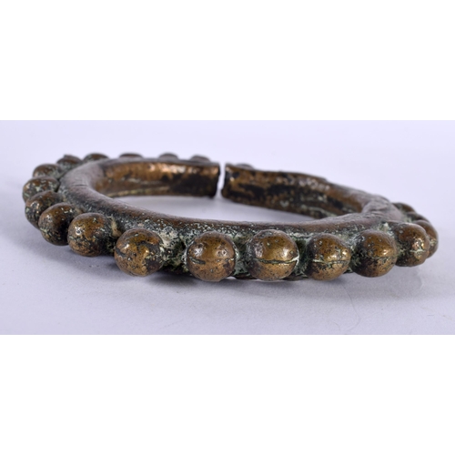 387 - AN EARLY INDIAN SOUTHEAST ASIAN BRONZE CUFF BANGLE together with a marble inlaid dish. Largest 22 cm... 