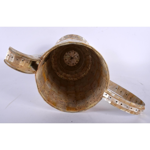 444 - AN INDIAN GOA MOTHER OF PEARL INLAID EWER with stud work decoration. 30 cm x 18 cm.