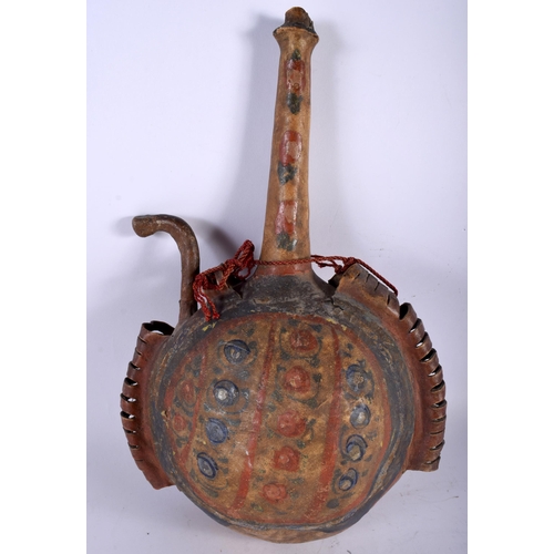 446 - AN ISLAMIC MIDDLE EASTERN PAINTED HIDE GUNPOWDER FLASK. 34 cm x 22 cm.