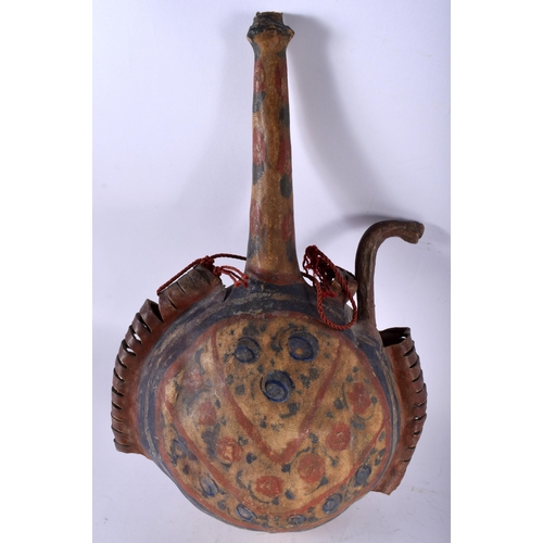 446 - AN ISLAMIC MIDDLE EASTERN PAINTED HIDE GUNPOWDER FLASK. 34 cm x 22 cm.