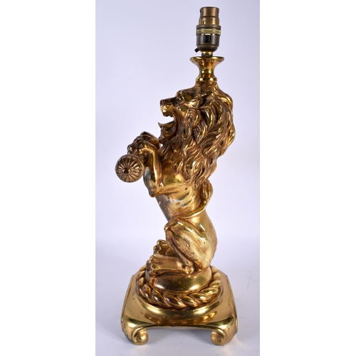 486 - AN ANTIQUE COUNTRY HOUSE GILDED LACQUER LION LAMP upon a gilt metal base. 42 cm x 15 cm.