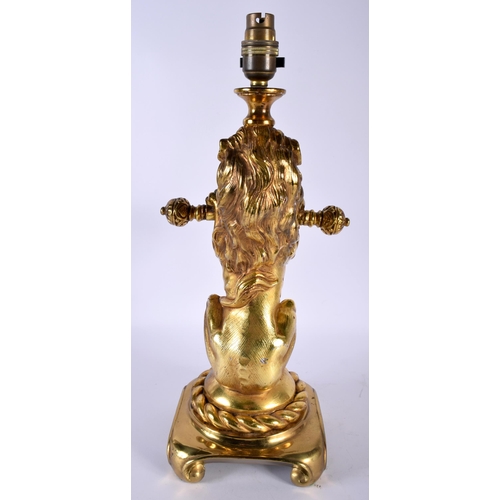 486 - AN ANTIQUE COUNTRY HOUSE GILDED LACQUER LION LAMP upon a gilt metal base. 42 cm x 15 cm.