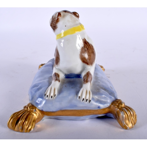 492 - A 19TH CENTURY GERMAN PORCELAIN FIGURE OF A SEATED HOUND modelled upon a lavender painted cushion. 1... 