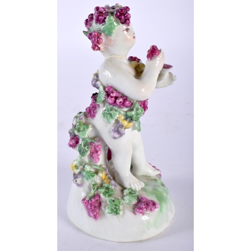 493 - AN 18TH CENTURY ENGLISH PORCELAIN FIGURE OF A PUTTI modelled encrusted in flowers. 13 cm high.