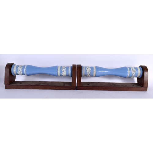 520A - AN UNUSUAL PAIR OF WEDGWOOD BLUE JASPERWARE TOWEL RAILS. 36 cm long.