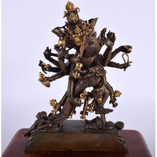 523A - A 19TH CENTURY CHINESE TIBETAN PARTIAL GILT BRONZE BUDDHA modelled as a multi armed male performing ... 