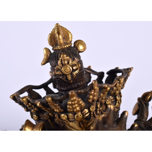 523A - A 19TH CENTURY CHINESE TIBETAN PARTIAL GILT BRONZE BUDDHA modelled as a multi armed male performing ... 