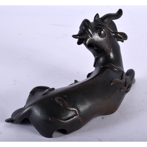 53 - A 17TH/18TH CENTURY CHINESE BRONZE FIGURE OF A STYLISED BEAST Ming/Qing, modelled as a recumbent bea... 