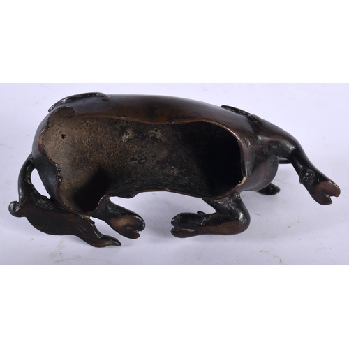 53 - A 17TH/18TH CENTURY CHINESE BRONZE FIGURE OF A STYLISED BEAST Ming/Qing, modelled as a recumbent bea... 