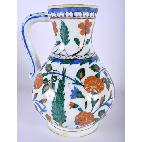 530 - A TURKISH IZNIK FAIENCE WATER JUG painted with flowers. 23 cm high.