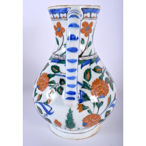 530 - A TURKISH IZNIK FAIENCE WATER JUG painted with flowers. 23 cm high.